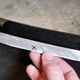 One of two trapezoidal patches. Another can be seen in-situ on the left; after welding a slight return was bent into their overhang to add further stiffness and match the original layout